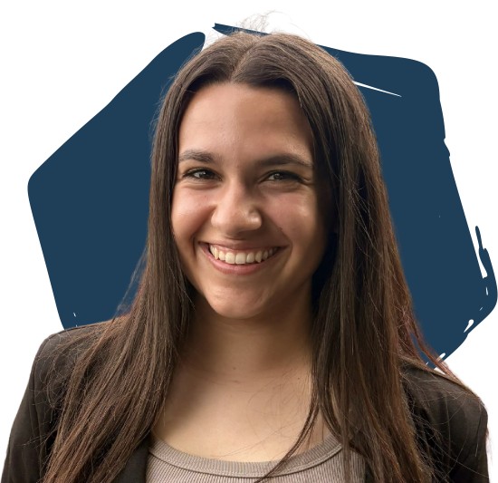 Bella in front of a blue hexagon.